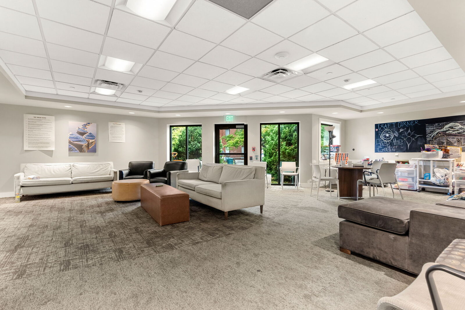 Large common room with sofas, games and a craft corner