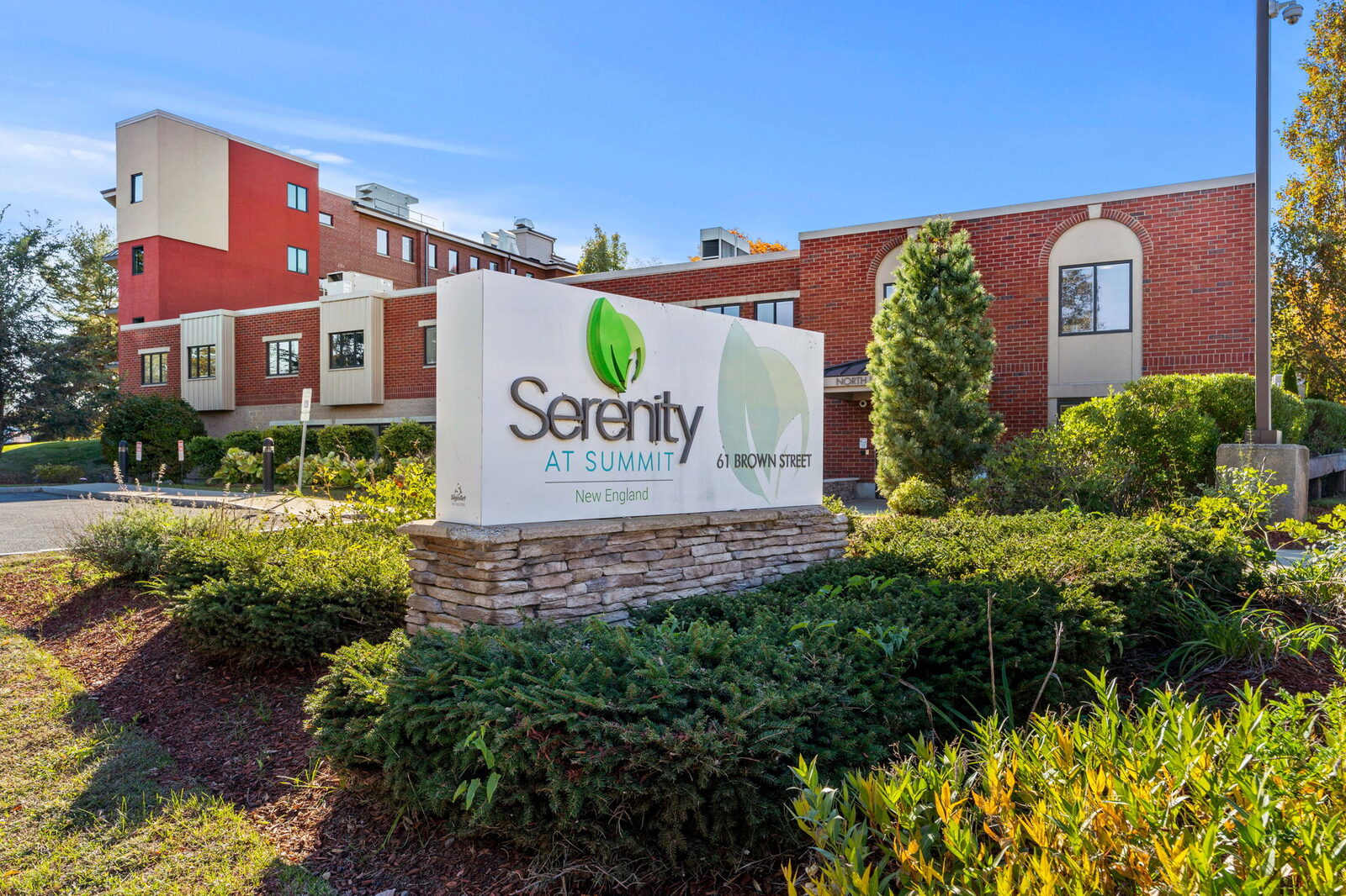 Brick building and Serenity at Summit New England sign
